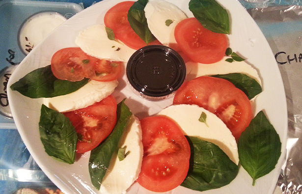 fresh mozzarella and tomato salad with basil and balsamic dressing served on a white plate showcasing eleven ingredients